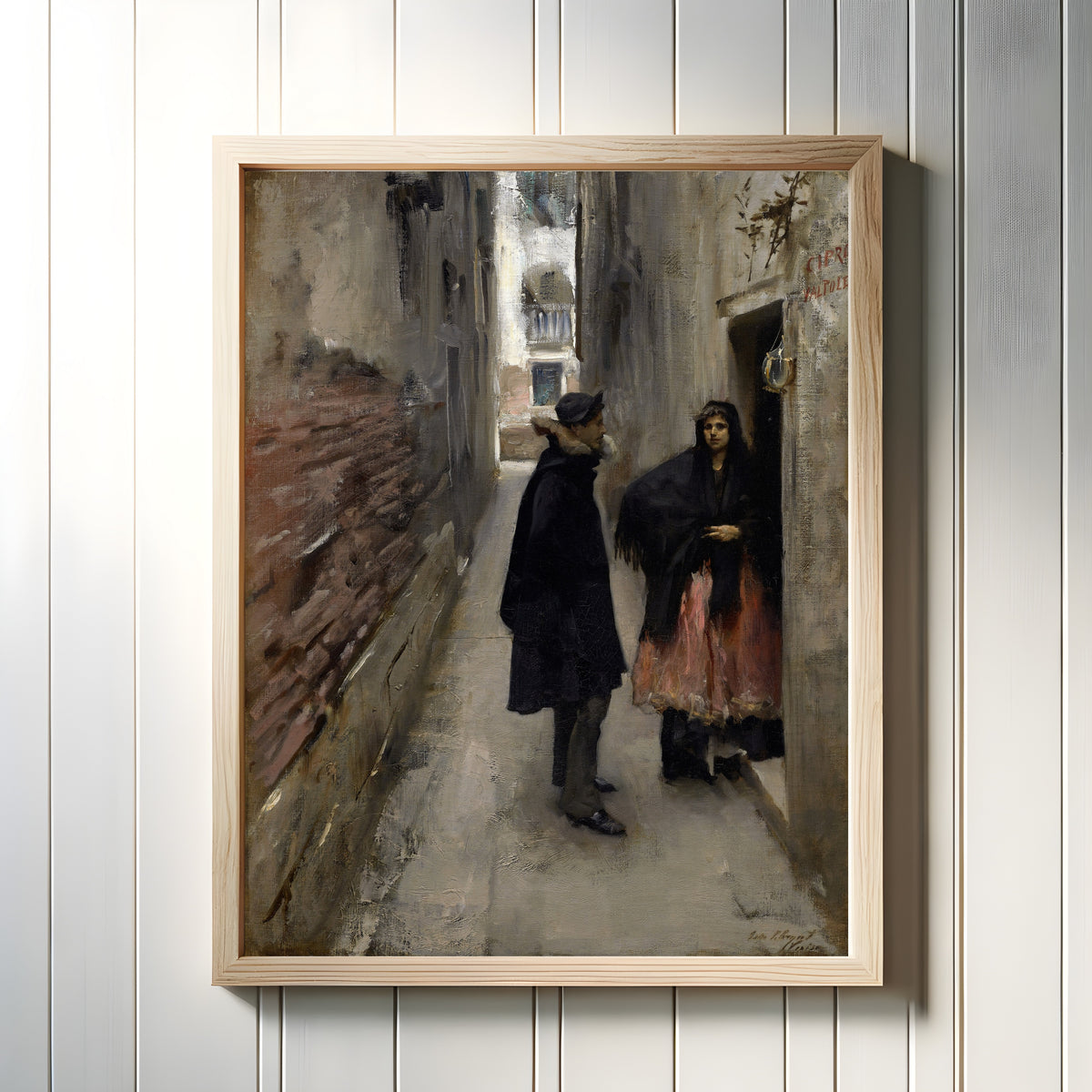 Framed art print of A Street in Venice by John Singer Sargent, in a light wood frame on a white panelled wall