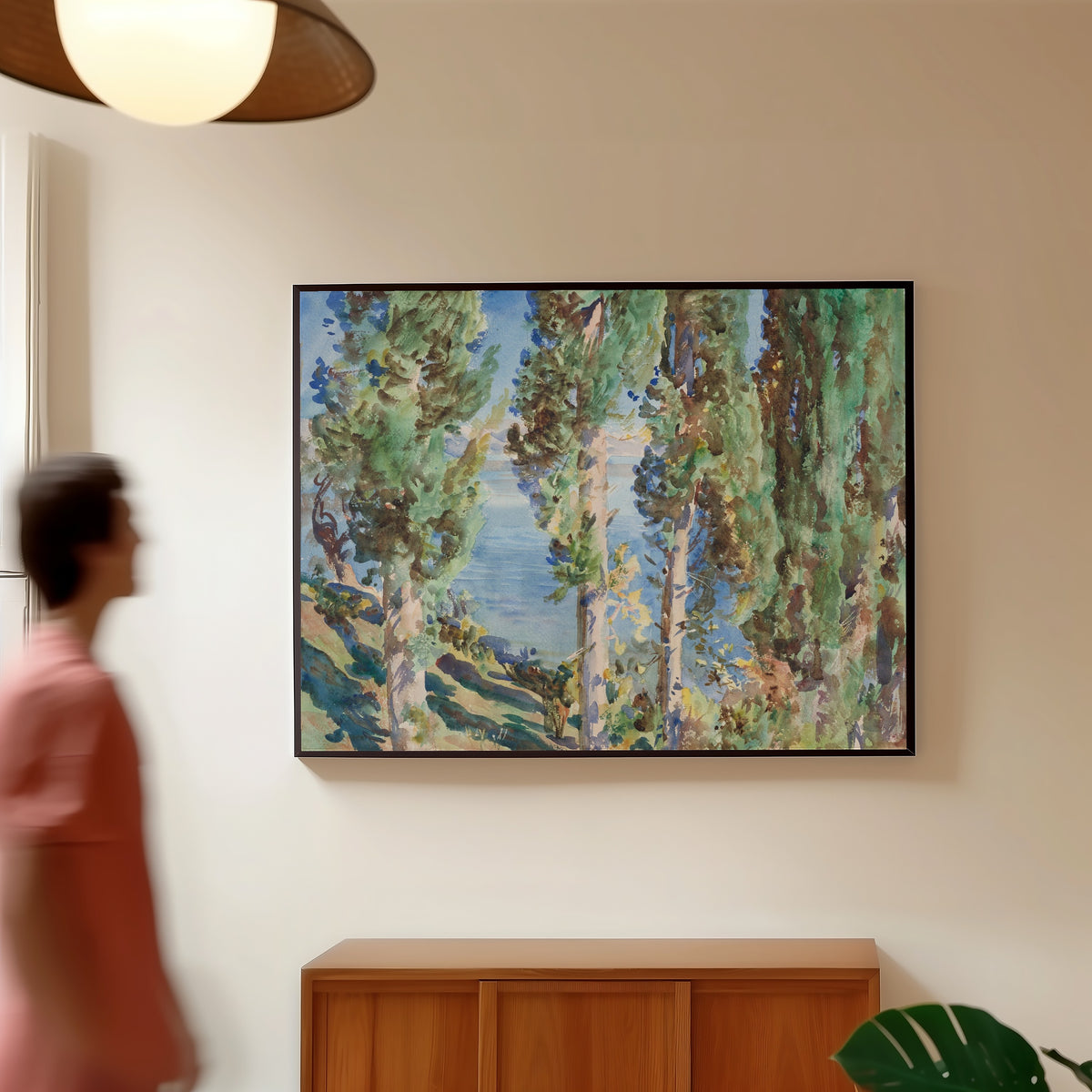 Framed art print of Corfu: Cypresses by John Singer Sargent, in a slim black frame on a warm wall in a sunlit room