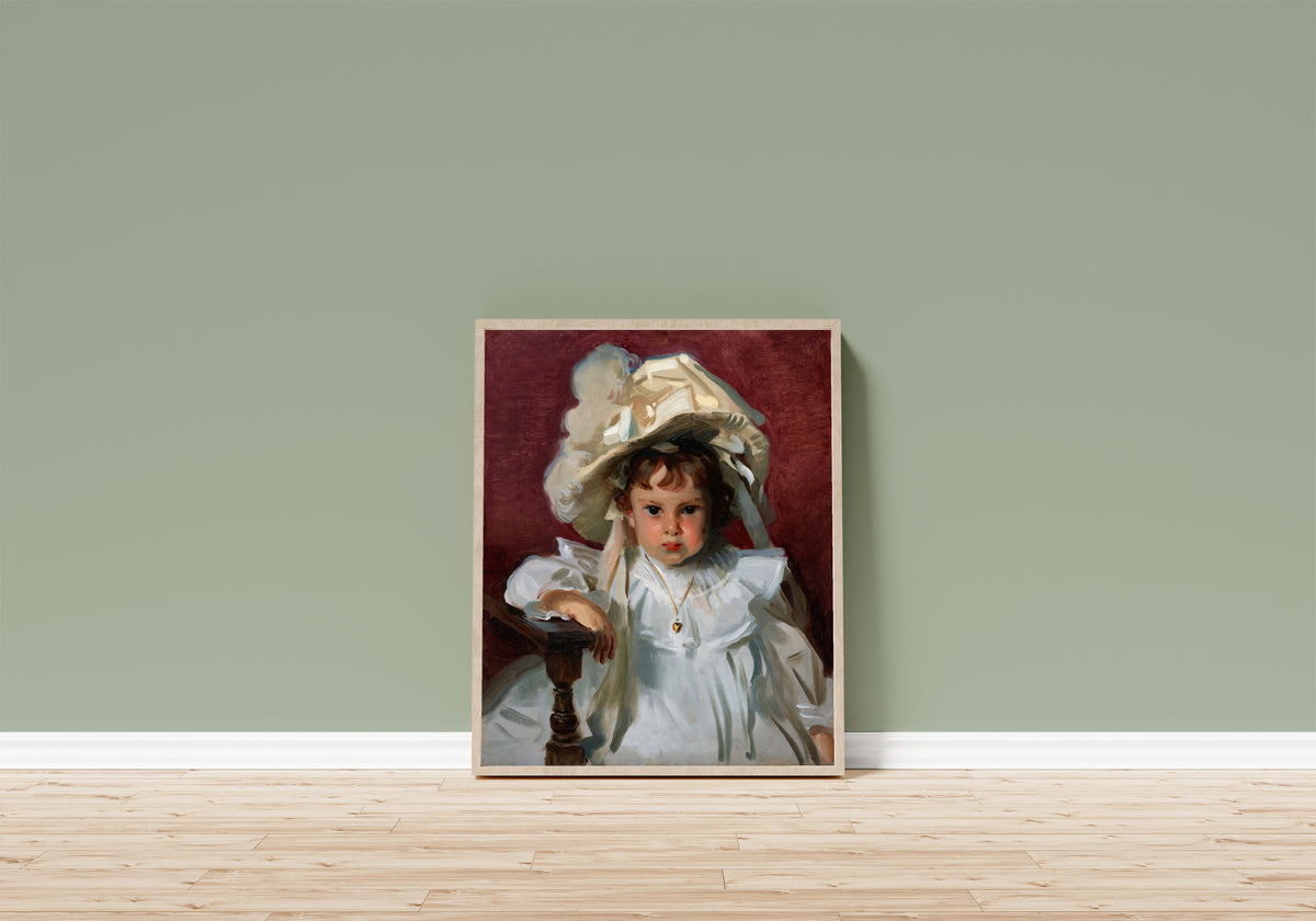 Framed art print of Dorothy by John Singer Sargent, in a light wood frame leaning on a sage green wall above a wooden floor