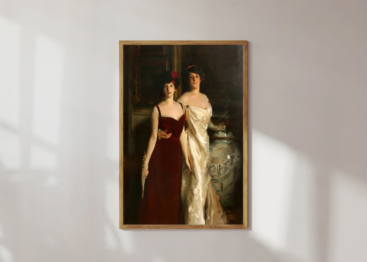 Framed art print of Ena and Betty, Daughters of Asher and Mrs. Wertheimer by John Singer Sargent, in a light wood frame on a sunlit white wall