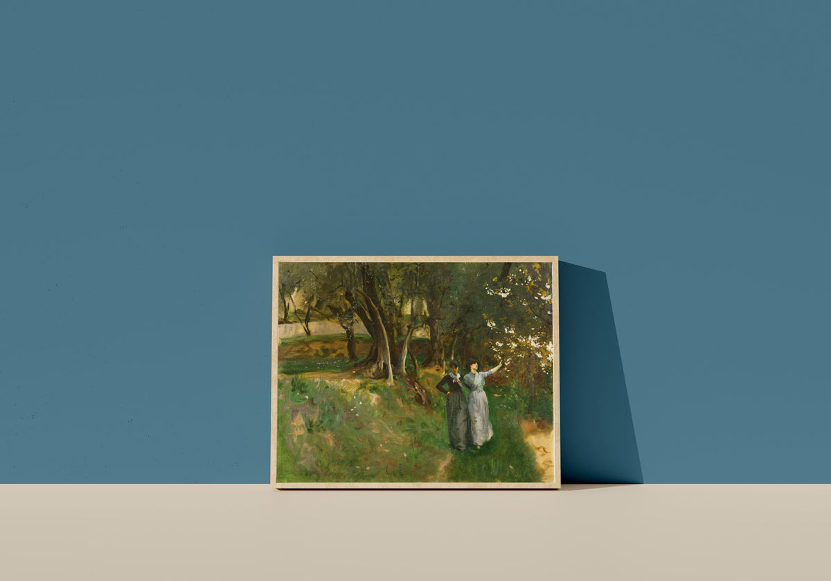 Framed art print of Landscape with Women in Foreground by John Singer Sargent, in a light wood frame leaning on a blue wall