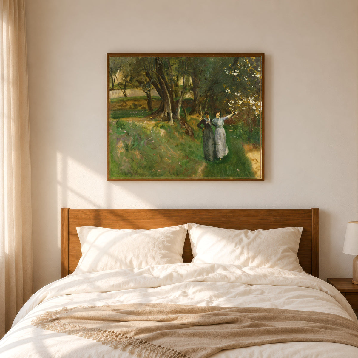 Framed art print of Landscape with Women in Foreground by John Singer Sargent, in a slim wood frame above a bed in a sunlit bedroom