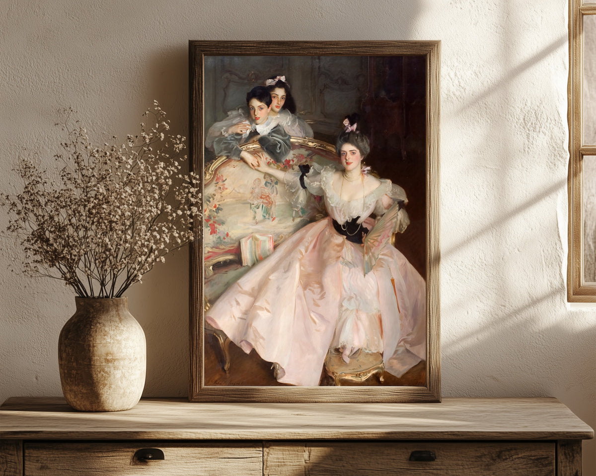 Framed art print of Mrs Carl Meyer and Her Children by John Singer Sargent, in a dark wood frame leaning on a rustic console beside dried flowers
