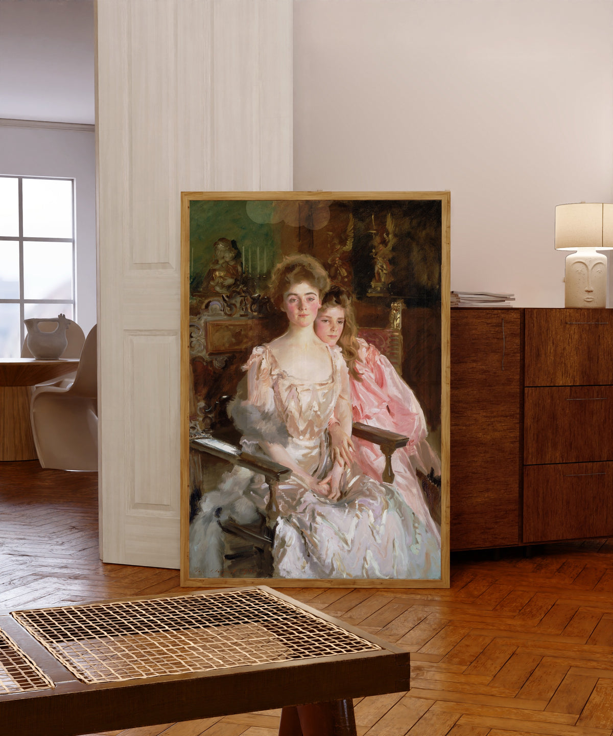 Framed art print of Mrs. Fiske Warren (Gretchen Osgood) and Her… by John Singer Sargent, in a light wood frame leaning in a warm room with a parquet floor