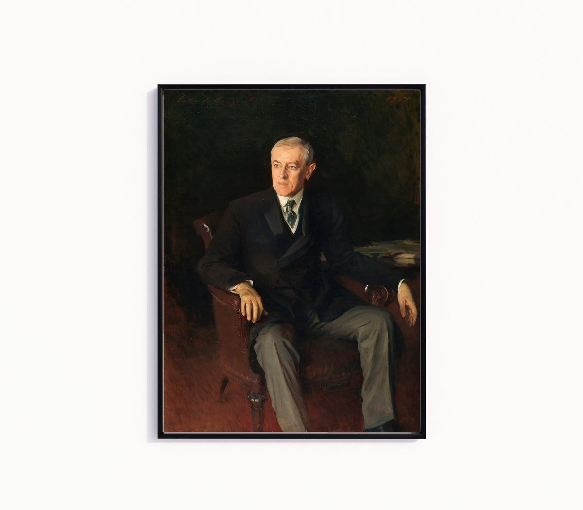 Framed art print of Portrait of Woodrow Wilson by John Singer Sargent, in a slim black frame on a plain white wall