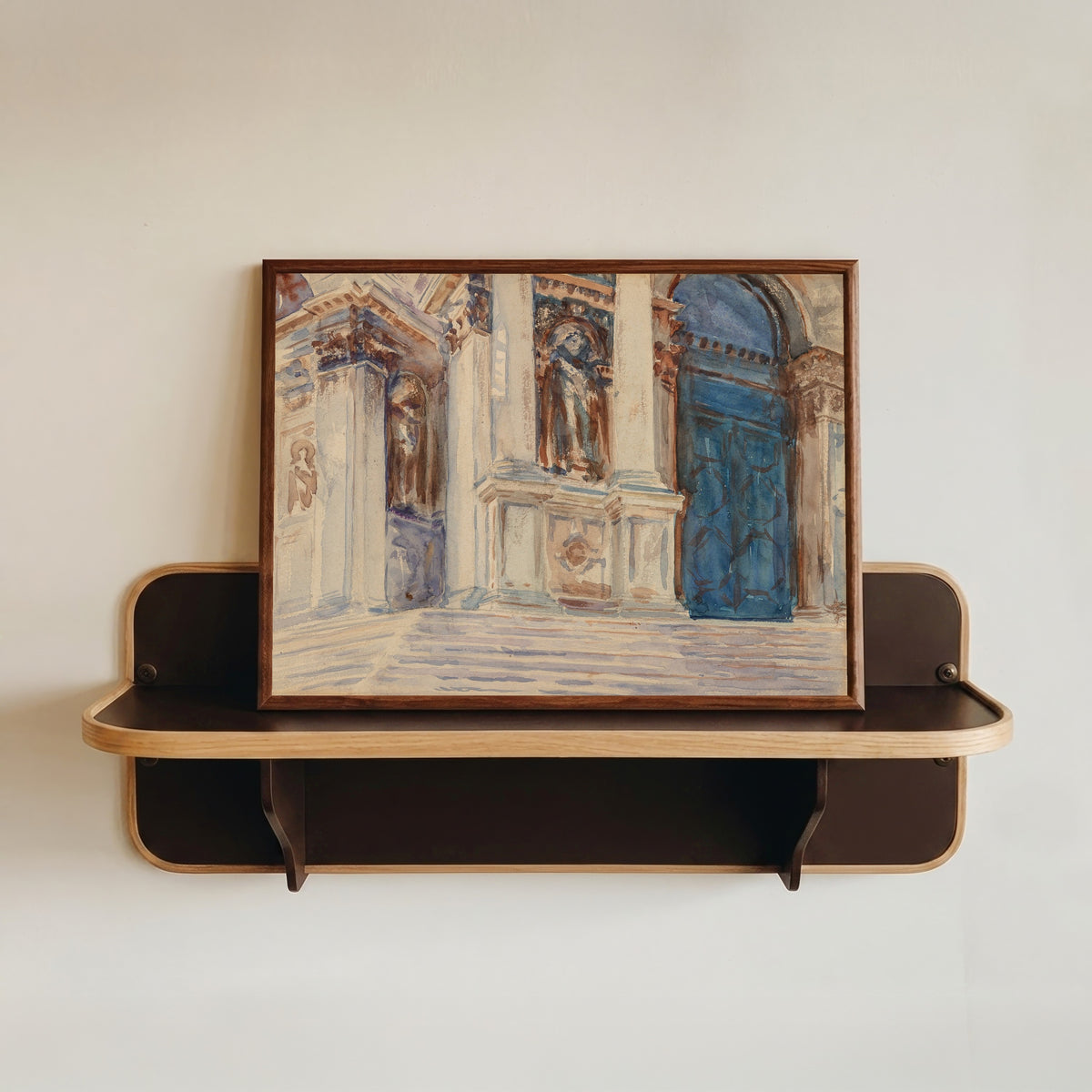 Framed art print of Santa Maria della Salute, Venice by John Singer Sargent, in a dark wood frame resting on a wall shelf