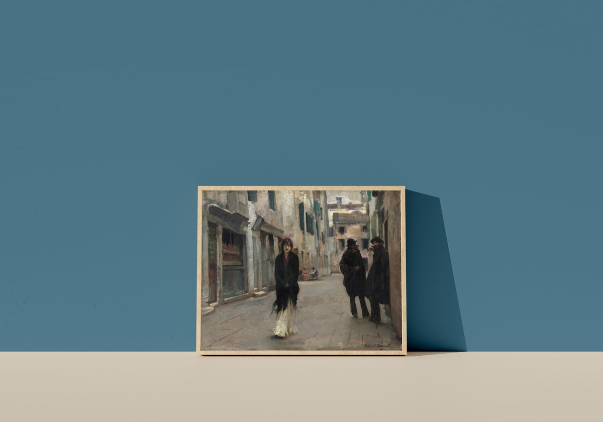 Framed art print of Street in Venice (Woman in a Black Shawl) by John Singer Sargent, in a light wood frame leaning on a blue wall