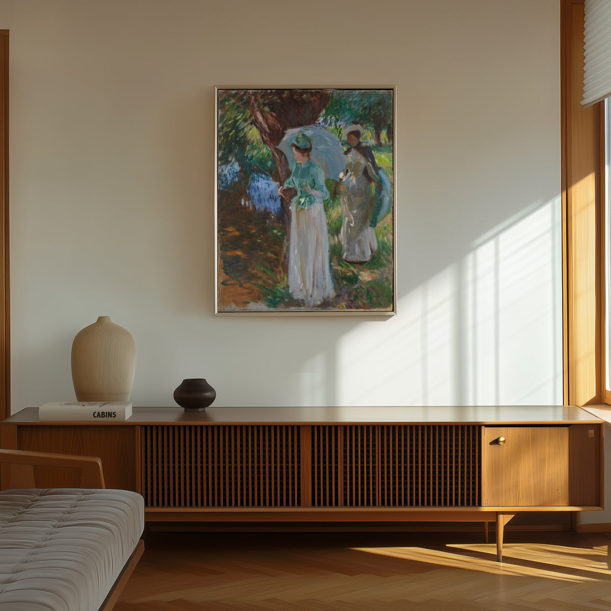 Framed art print of Two Girls with Parasols by John Singer Sargent, in a thin light frame on a sunlit wall above a wooden sideboard