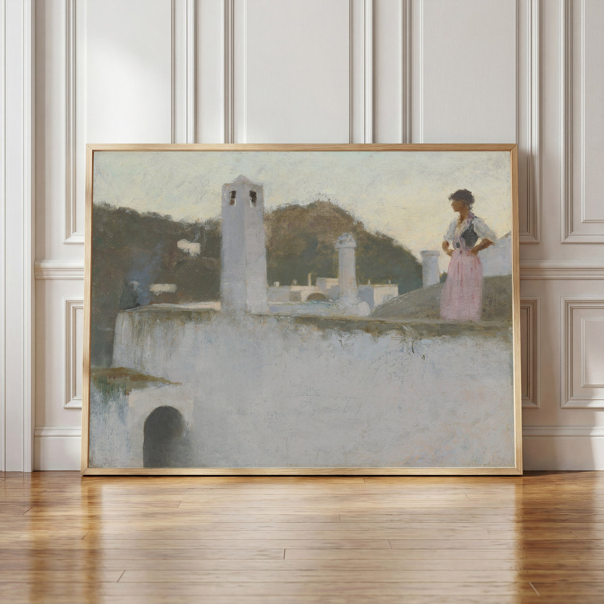 Framed art print of View of Capri by John Singer Sargent, in a light wood frame leaning against a panelled white wall