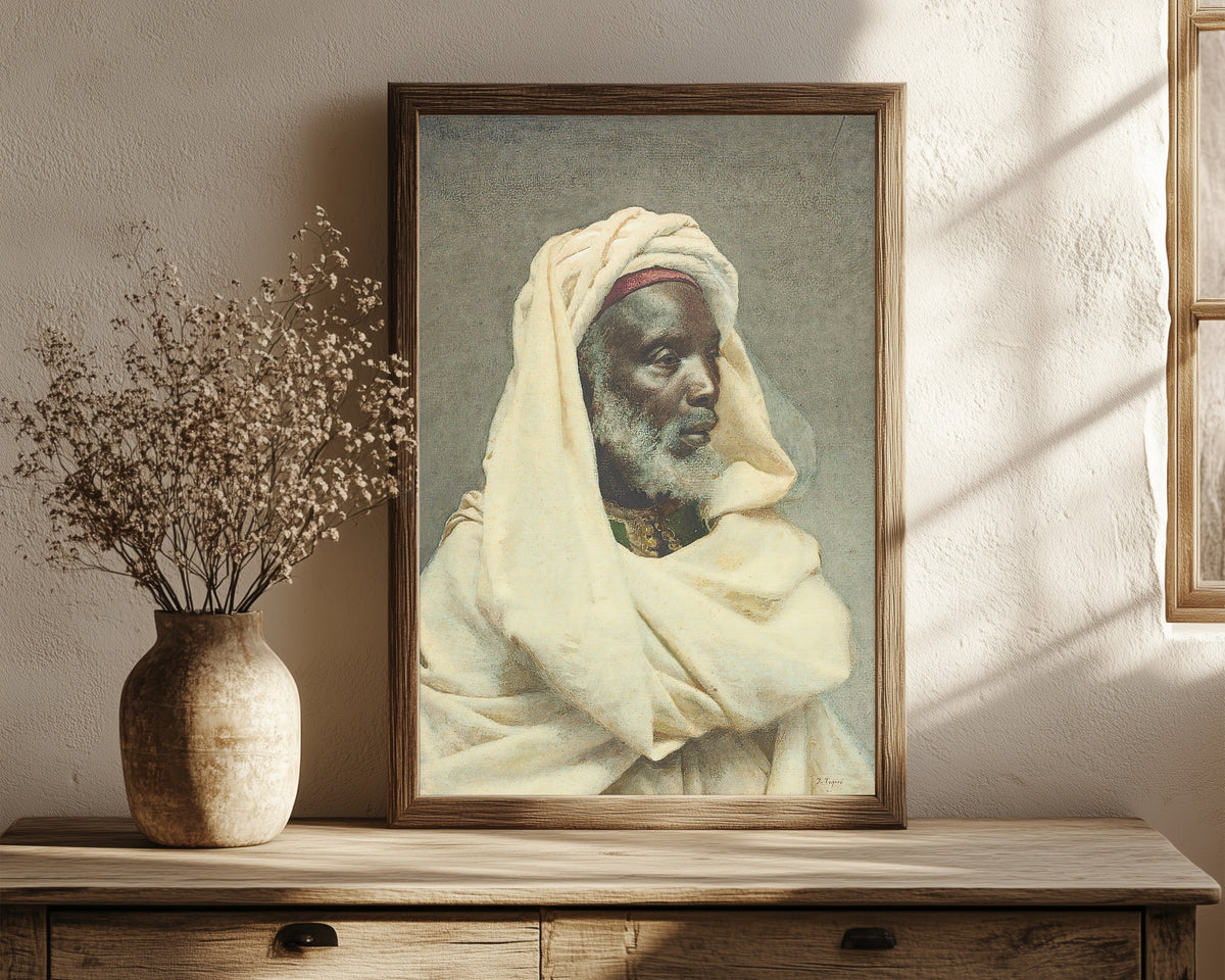 Framed art print of Moorish Elder by Josep Tapiró Baró, in a dark wood frame leaning on a rustic console beside dried flowers