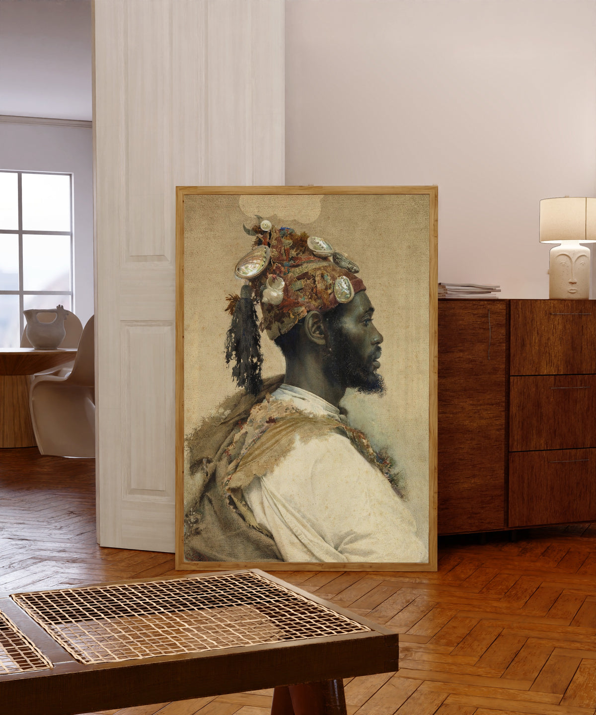 Framed art print of Moorish Man 2 by Josep Tapiró Baró, in a light wood frame leaning in a warm room with a parquet floor