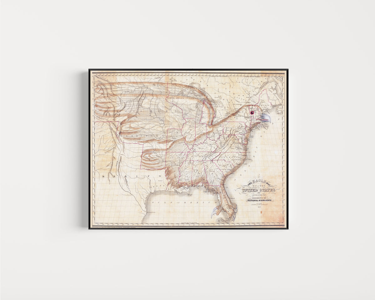 Framed art print of The Eagle Map of the United States by Joseph Churchman, in a slim black frame on a plain white wall