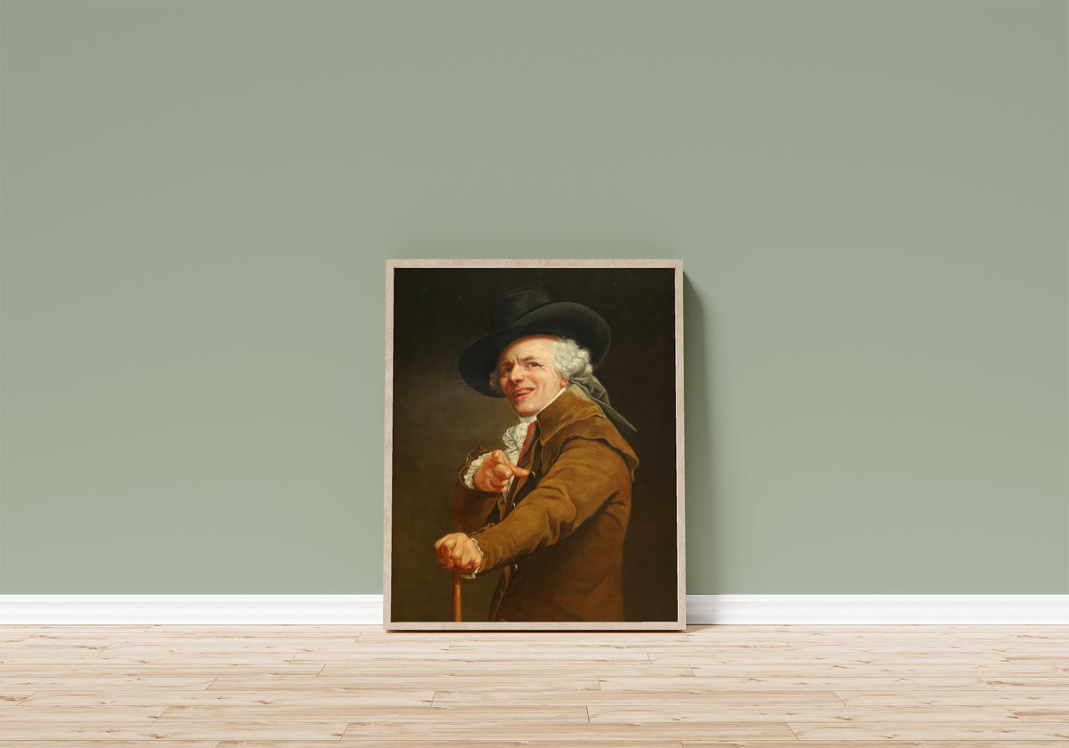 Framed art print of Self-portrait, Yawning / Mocking by Joseph Ducreux, in a light wood frame leaning on a sage green wall above a wooden floor