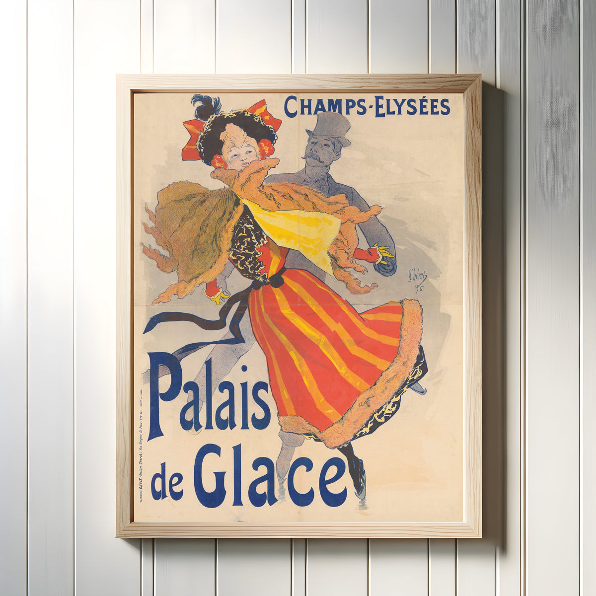 Framed art print of Palais de Glace, Champs-Élysées by Jules Chéret, in a light wood frame on a white panelled wall
