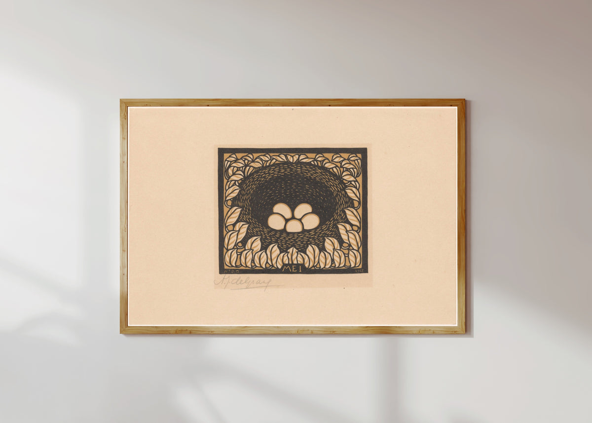 Framed art print of Bird's nest with eggs by Julie de Graag, in a light wood frame on a sunlit white wall