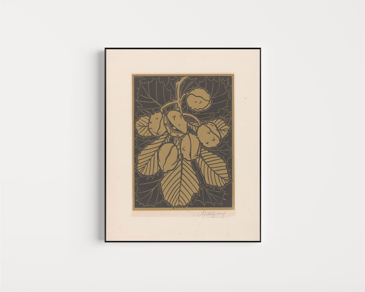 Framed art print of Hazelnuts and leaves by Julie de Graag, in a slim black frame on a plain white wall