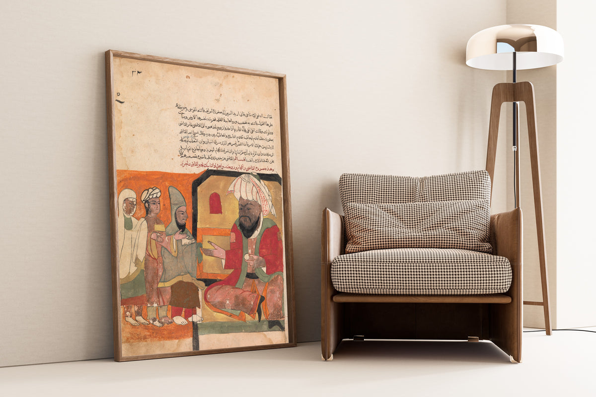 Framed art print of Kalila wa Dimna: Folio (Orange Ground), leaning against a wall beside an armchair and a floor lamp