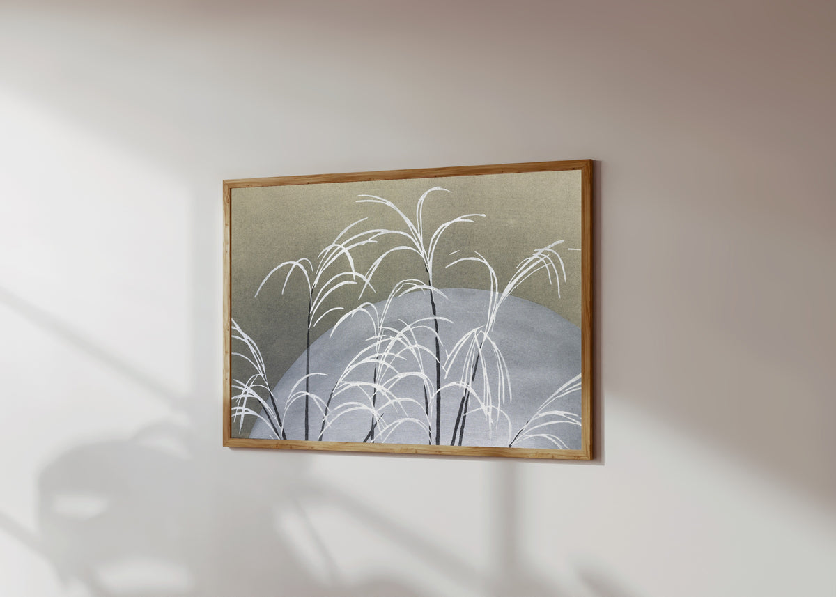 Framed art print of Frost, from Momoyogusa by Kamisaka Sekka, in a light wood frame on a sunlit white wall, seen at a slight angle