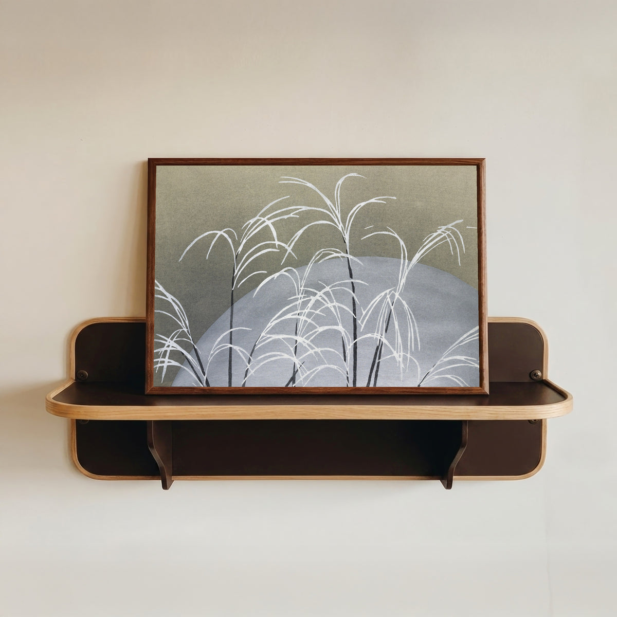 Framed art print of Frost, from Momoyogusa by Kamisaka Sekka, in a dark wood frame resting on a wall shelf