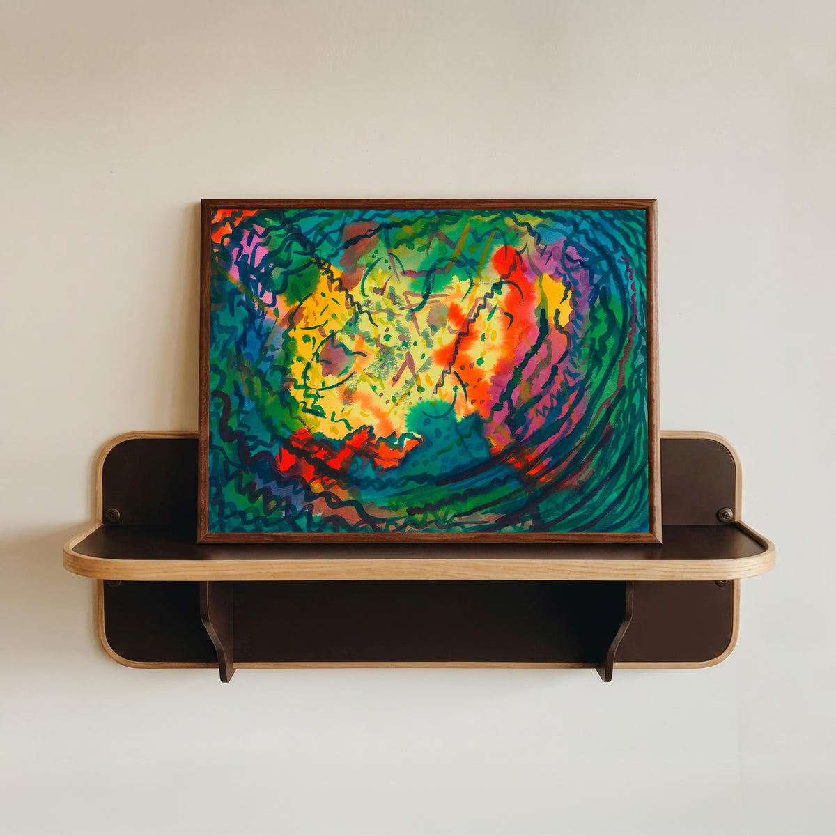 Framed art print of Auflösung (Dissolution) by Karl Wiener, in a dark wood frame resting on a wall shelf