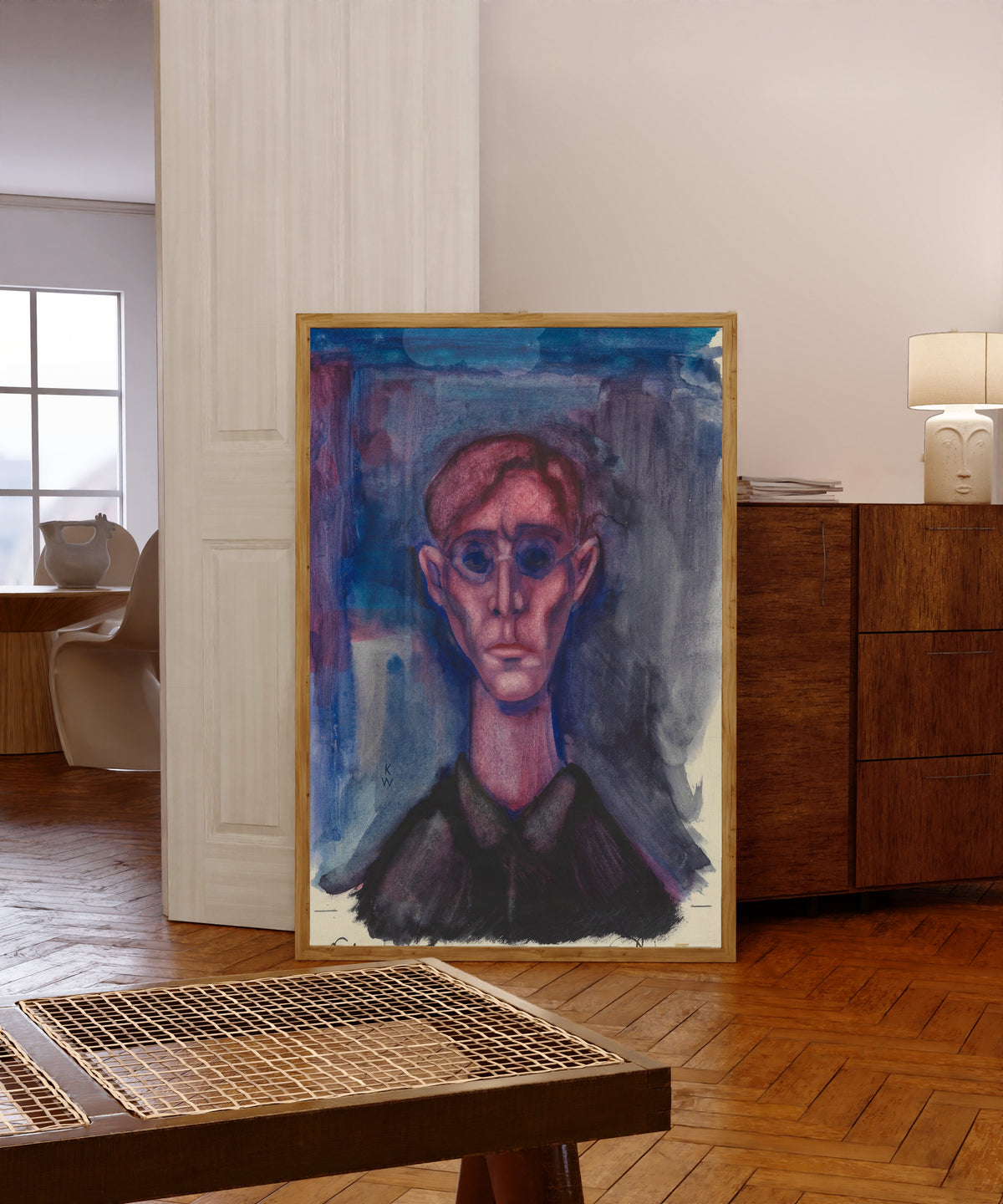 Framed art print of Depression, Selbstporträt (Depression, Self-Portrait) by Karl Wiener, in a light wood frame leaning in a warm room with a parquet floor