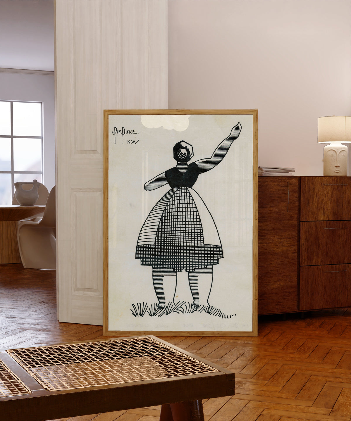 Framed art print of Die Dicke (The Stout Woman) by Karl Wiener, in a light wood frame leaning in a warm room with a parquet floor