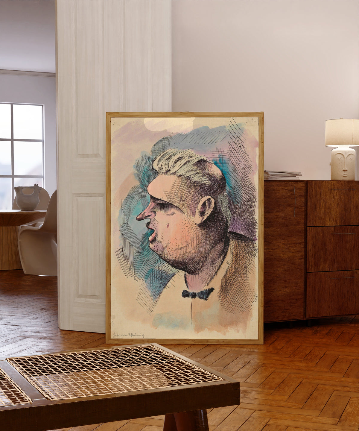 Framed art print of Herr von Schleimig (Mr von Slimy) by Karl Wiener, in a light wood frame leaning in a warm room with a parquet floor