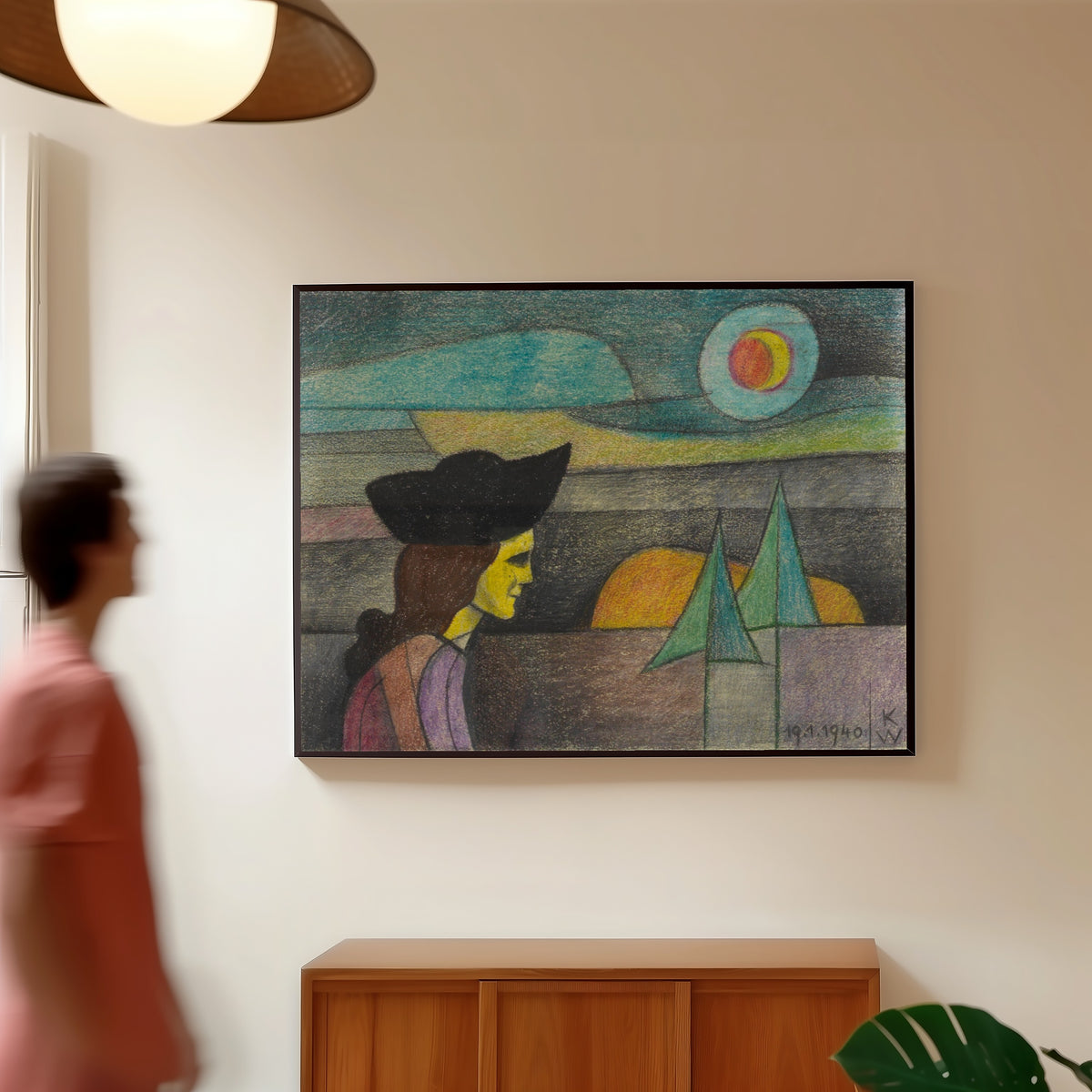 Framed art print of Untitled (Woman with a Black Hat) by Karl Wiener, in a slim black frame on a warm wall in a sunlit room