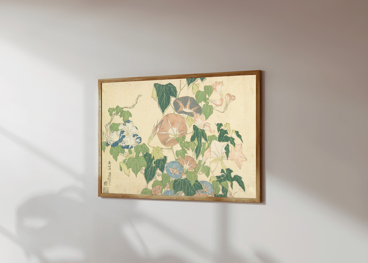 Framed art print of Large Flowers: Morning Glories and Tree-frog by Katsushika Hokusai, in a light wood frame on a sunlit white wall, seen at a slight angle