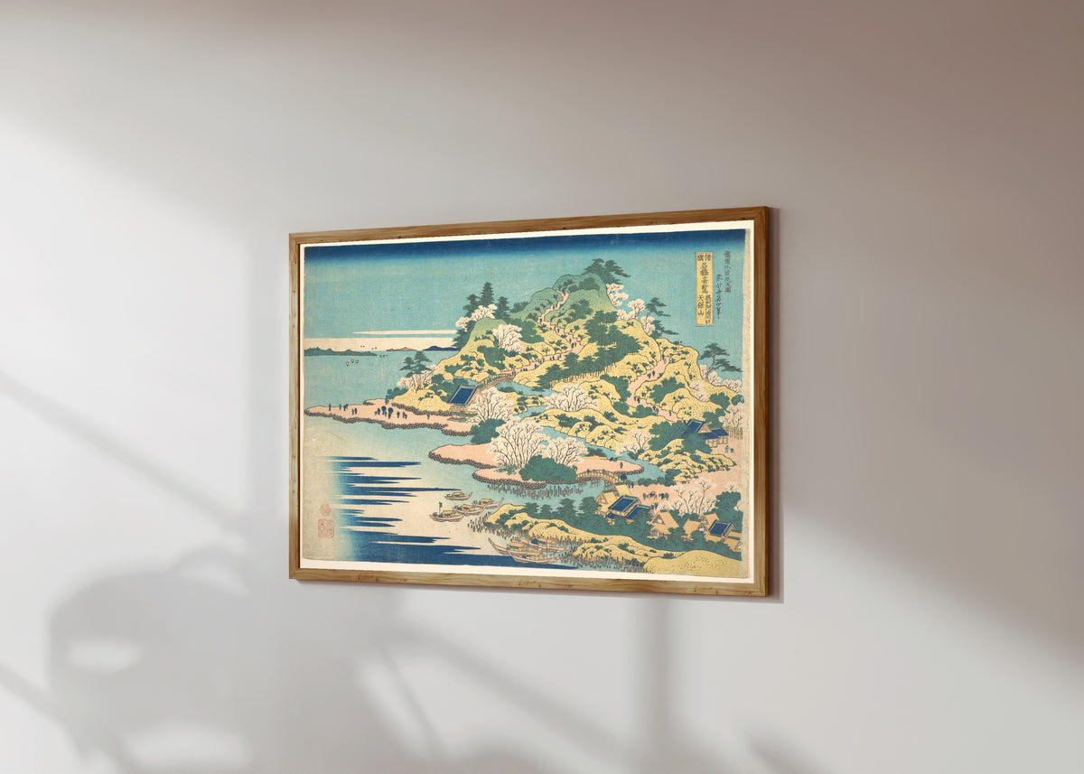 Framed art print of Remarkable Views of Bridges in Various… by Katsushika Hokusai, in a light wood frame on a sunlit white wall, seen at a slight angle