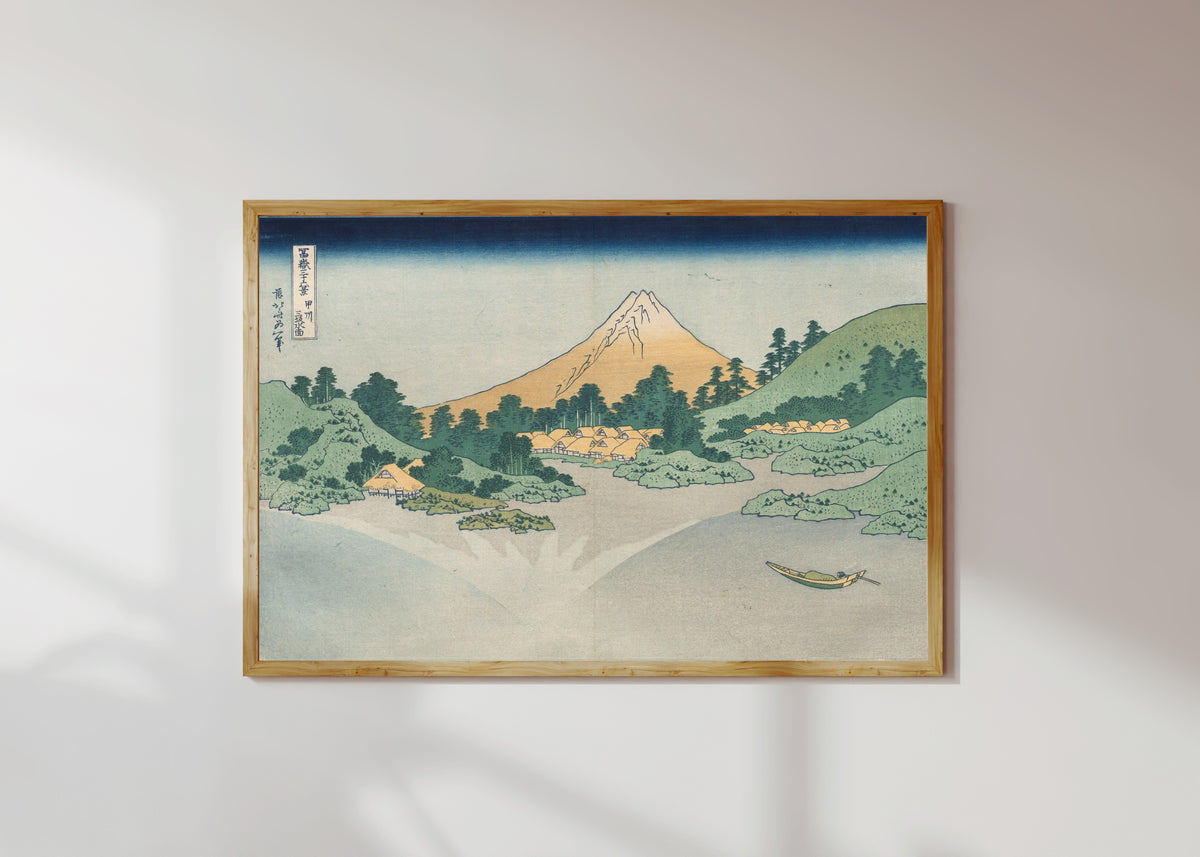 Framed art print of Thirty-six Views of Mount Fuji: The Surface of Lake Misaka in Kai… by Katsushika Hokusai, in a light wood frame on a sunlit white wall