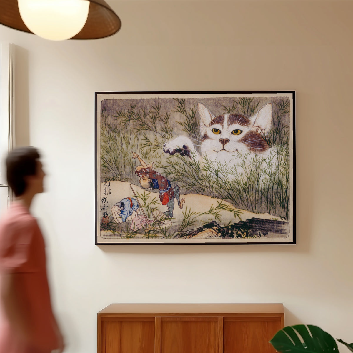 Framed art print of Seisei Kyōsai Album (Giant Cat in the Grass) by Kawanabe Kyosai, in a slim black frame on a warm wall in a sunlit room