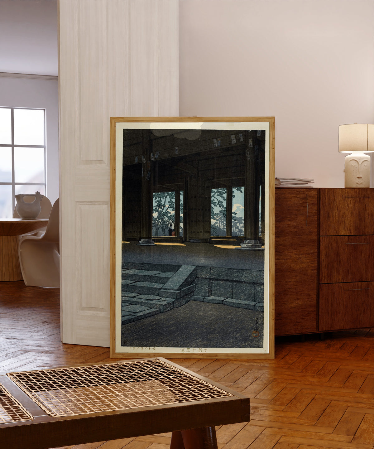 Framed art print of Chion Temple, Kyoto by Kawase Hasui, in a light wood frame leaning in a warm room with a parquet floor