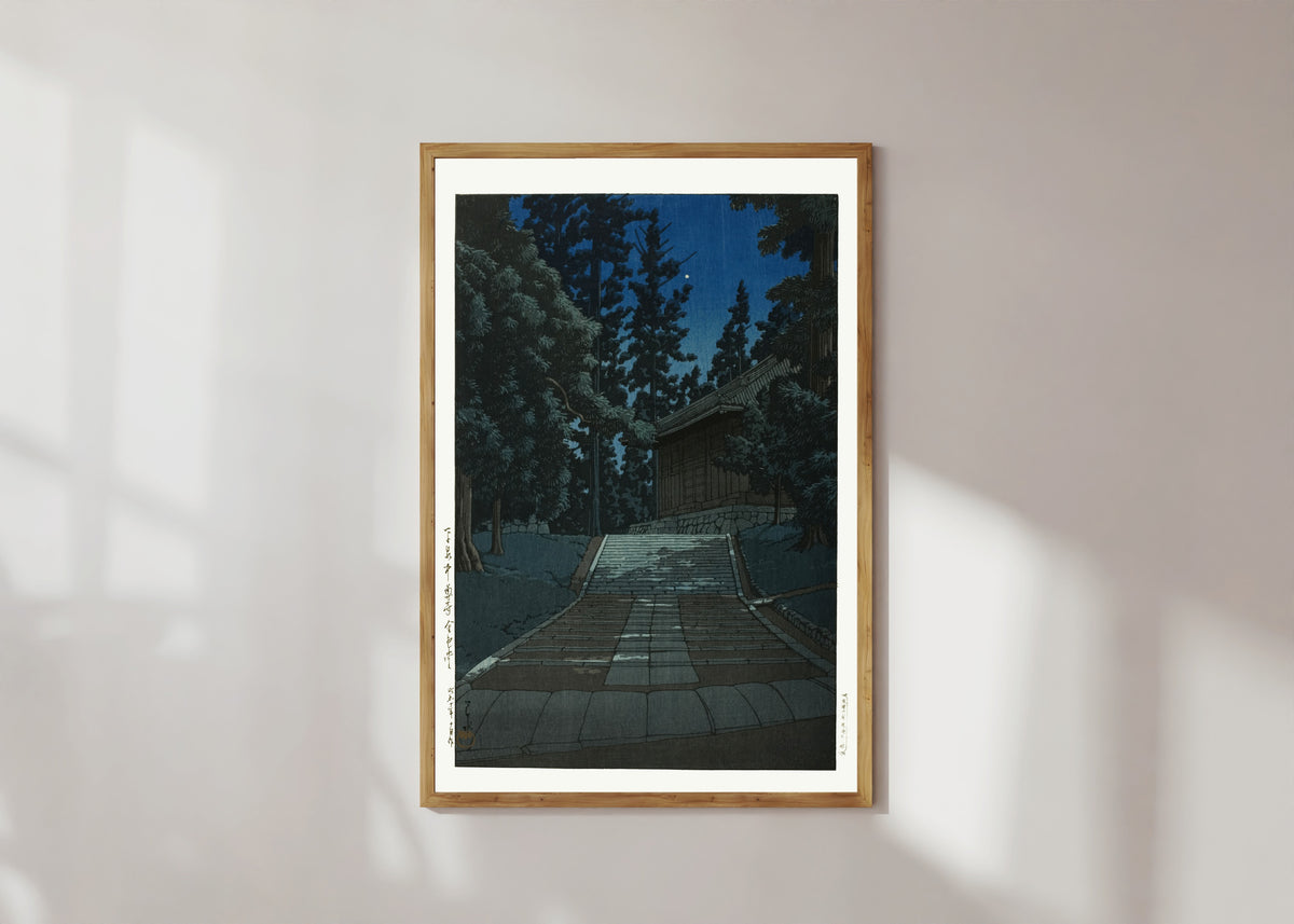 Framed art print of Konjikido at Chusonji, Hiraizumi, at Night by Kawase Hasui, in a light wood frame on a sunlit white wall