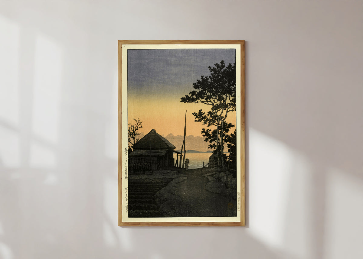 Framed art print of Dusk at Aso, Ibaraki by Kawase Hasui, in a light wood frame on a sunlit white wall