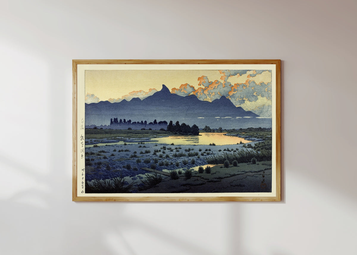Framed art print of Maebashi Marshes by Kawase Hasui, in a light wood frame on a sunlit white wall