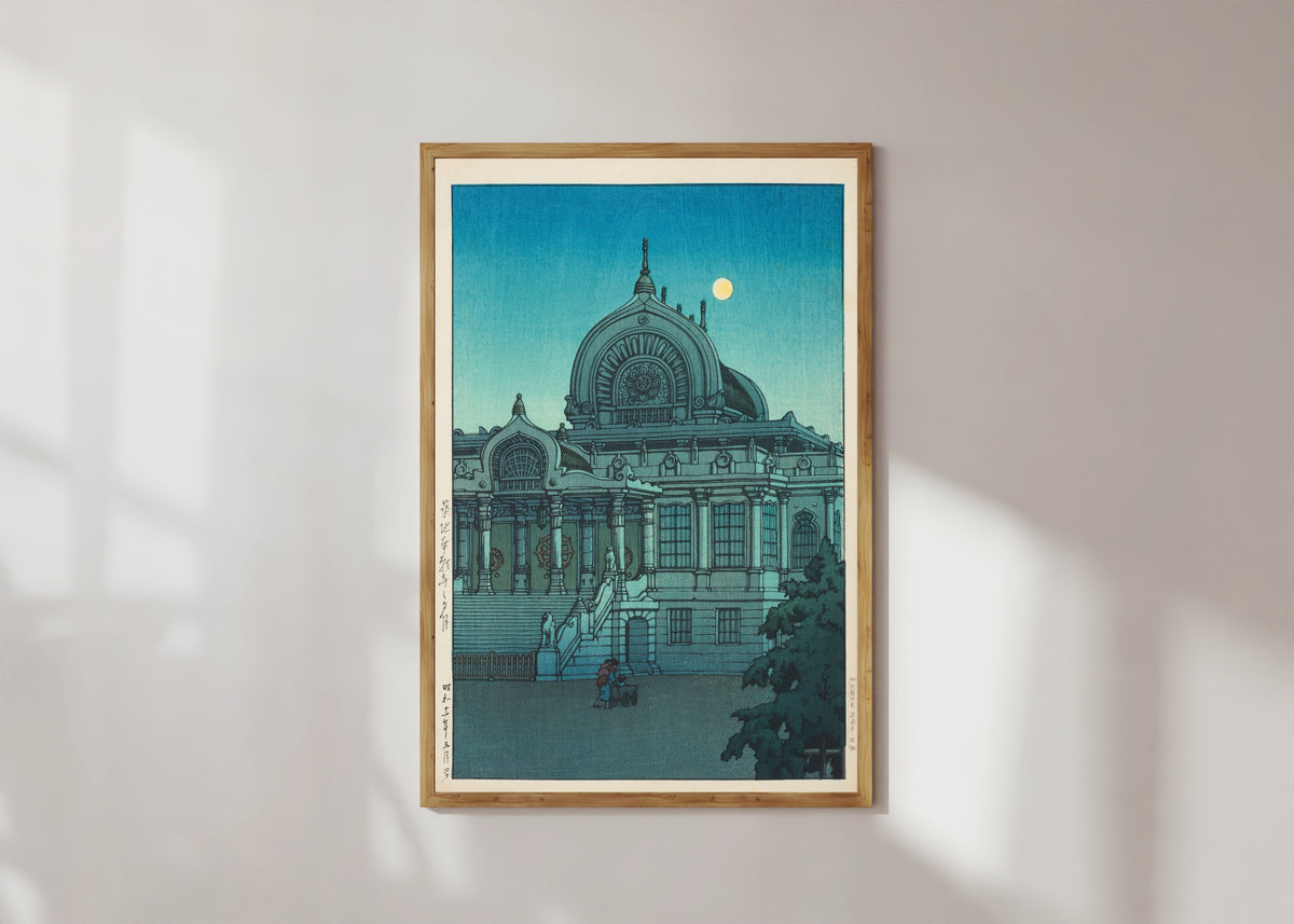 Framed art print of Evening Moon at Honganji Temple, Tsukiji by Kawase Hasui, in a light wood frame on a sunlit white wall