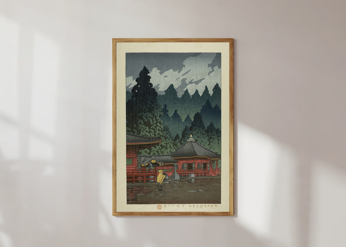 Framed art print of Futatsudo Hall, Nikko by Kawase Hasui, in a light wood frame on a sunlit white wall