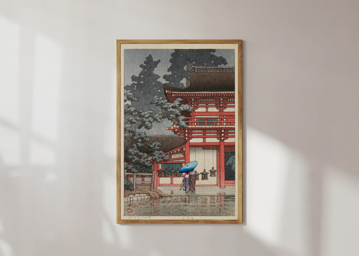 Framed art print of Kasuga Shrine, Nara by Kawase Hasui, in a light wood frame on a sunlit white wall