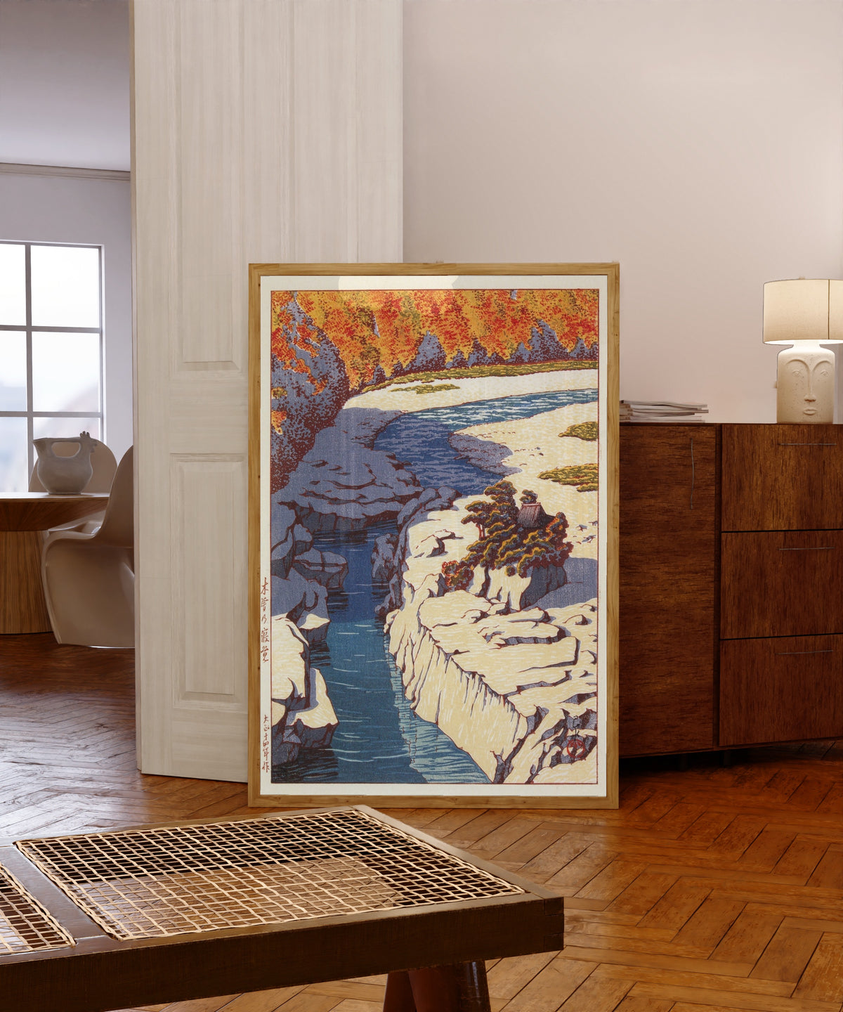 Framed art print of Kizo no Nezame by Kawase Hasui, in a light wood frame leaning in a warm room with a parquet floor