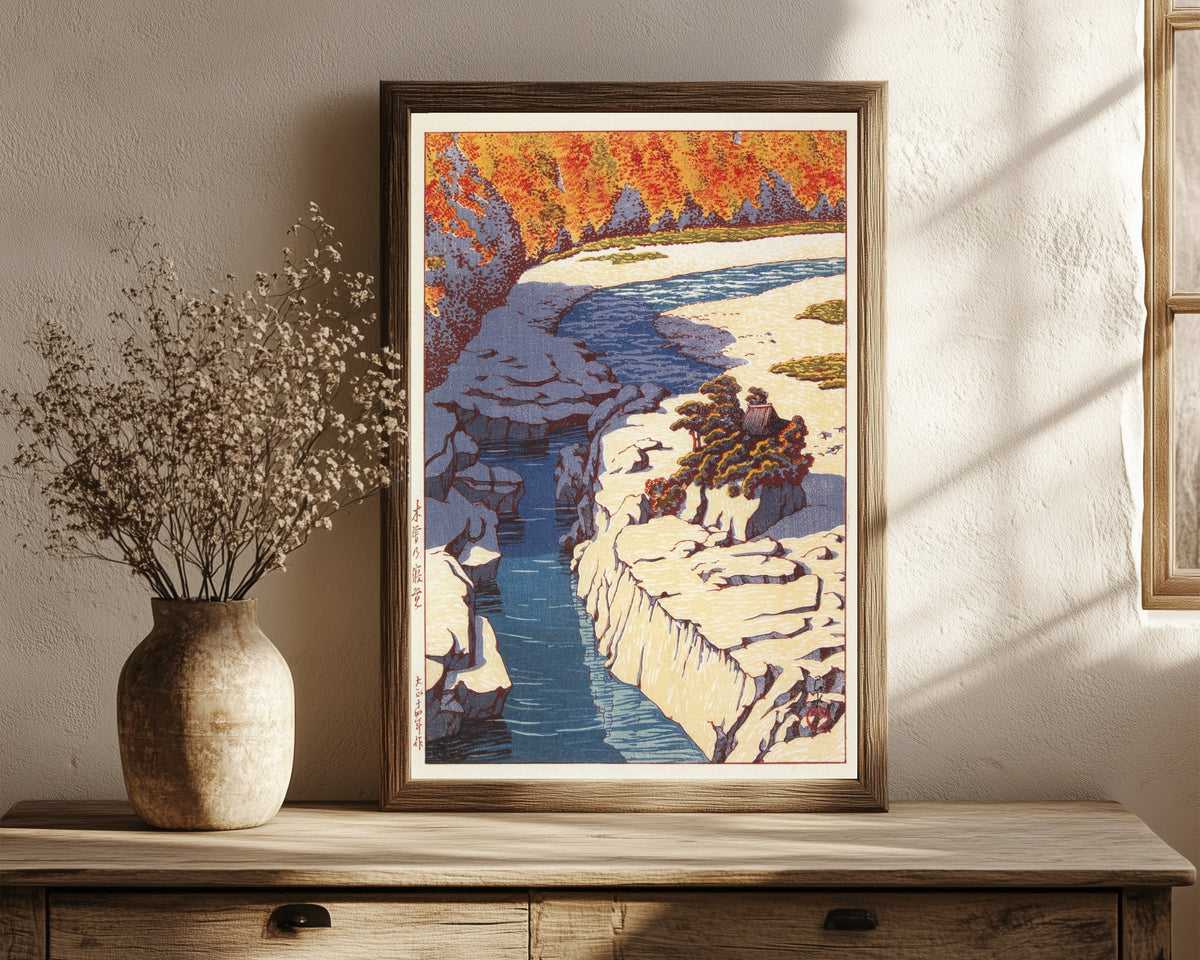 Framed art print of Kizo no Nezame by Kawase Hasui, in a dark wood frame leaning on a rustic console beside dried flowers