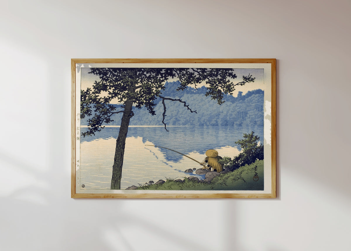 Framed art print of Lake Matsubara by Kawase Hasui, in a light wood frame on a sunlit white wall