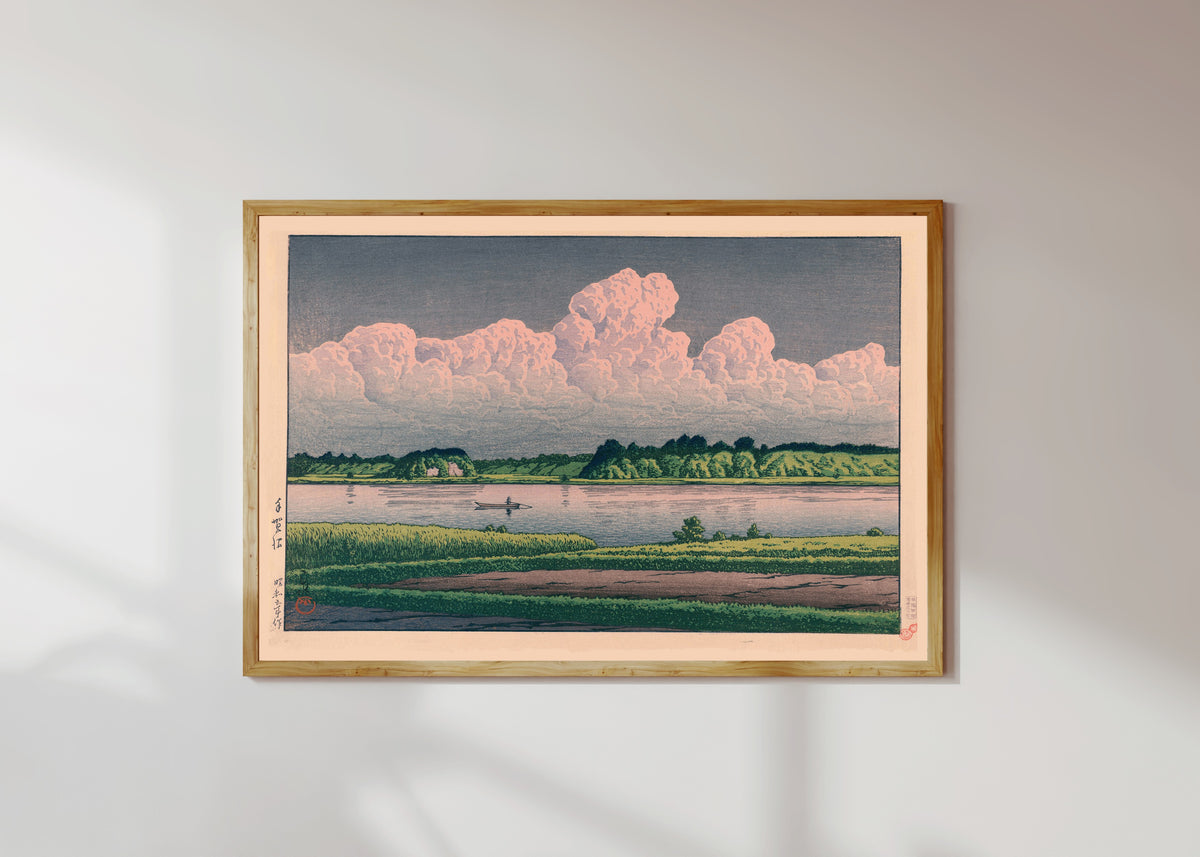 Framed art print of Lake Teganuma by Kawase Hasui, in a light wood frame on a sunlit white wall