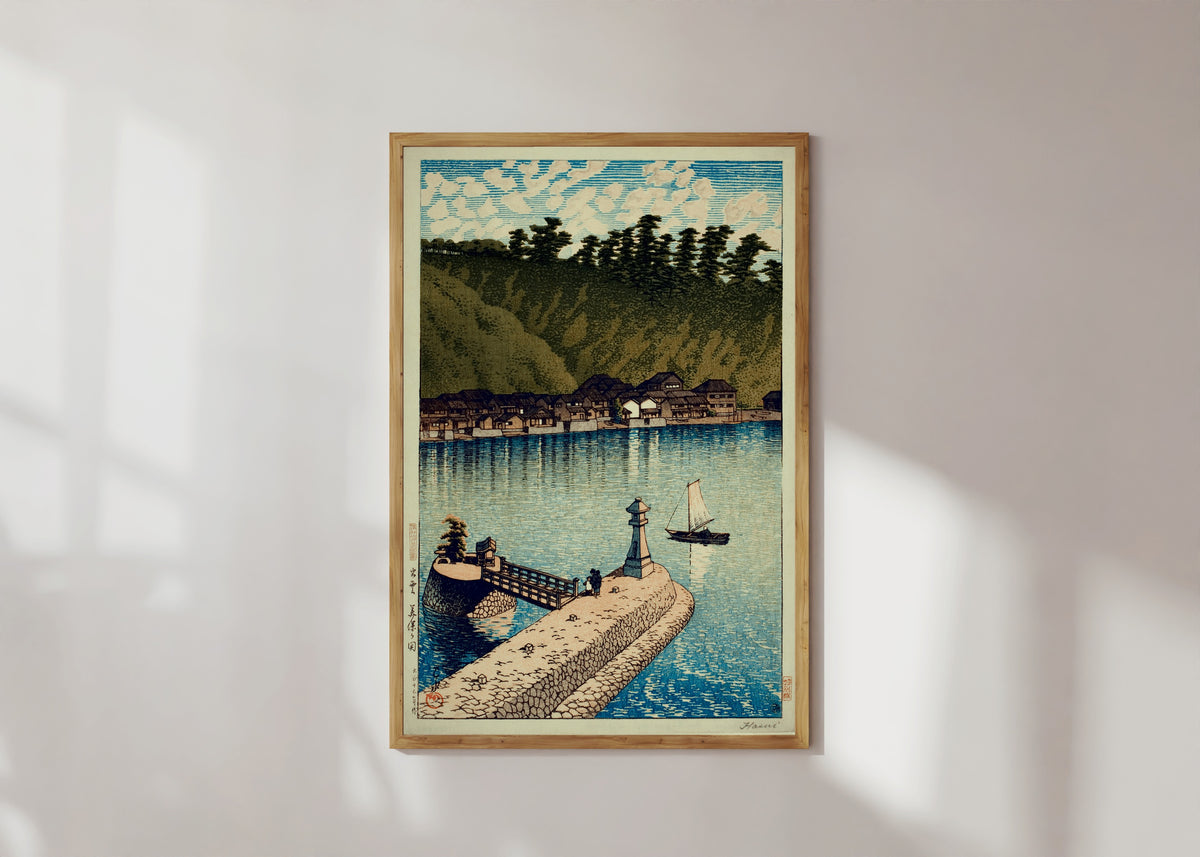 Framed art print of Mihogaseki Bridge by Kawase Hasui, in a light wood frame on a sunlit white wall