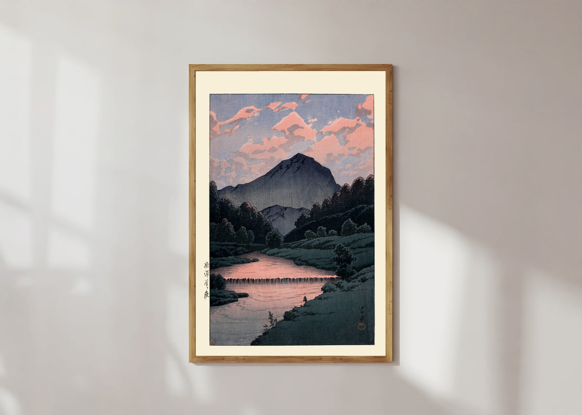 Framed art print of Mount Kamagatake, Hida by Kawase Hasui, in a light wood frame on a sunlit white wall