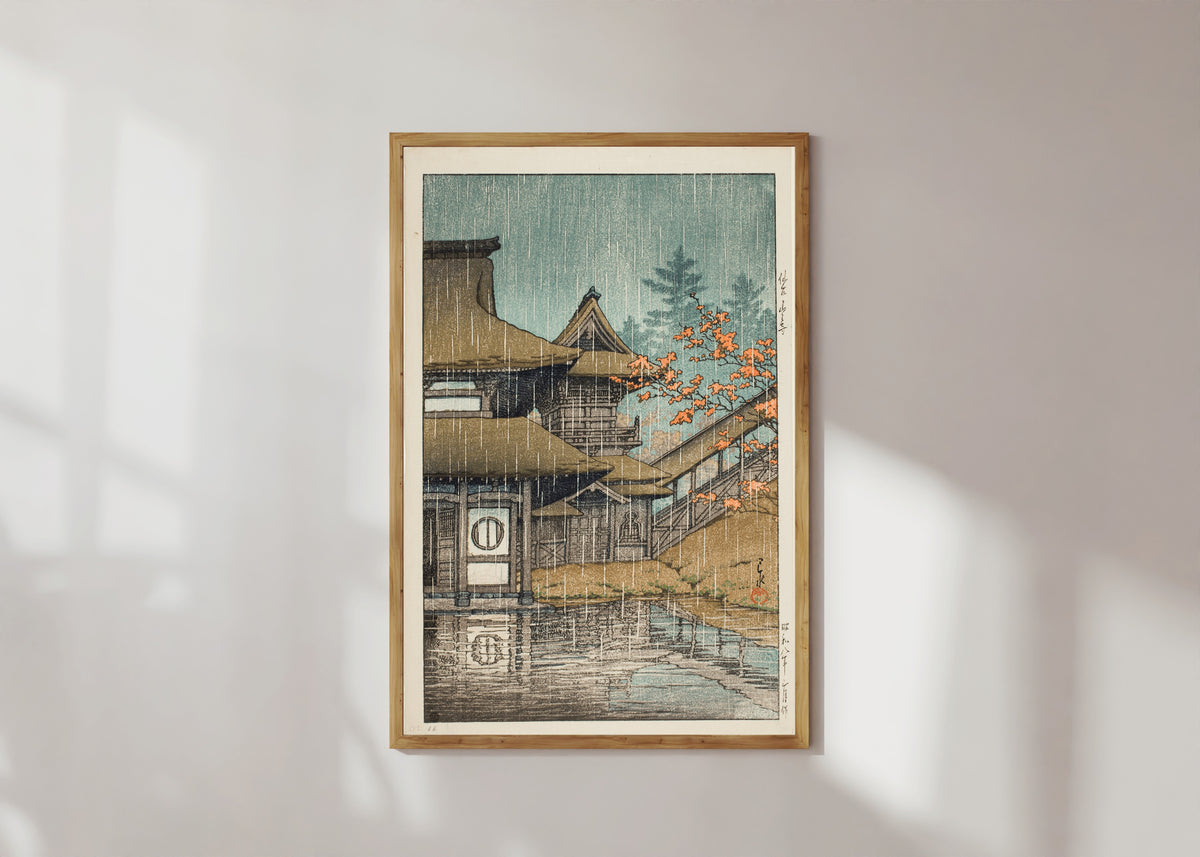 Framed art print of Yamadera Temple in Rain by Kawase Hasui, in a light wood frame on a sunlit white wall