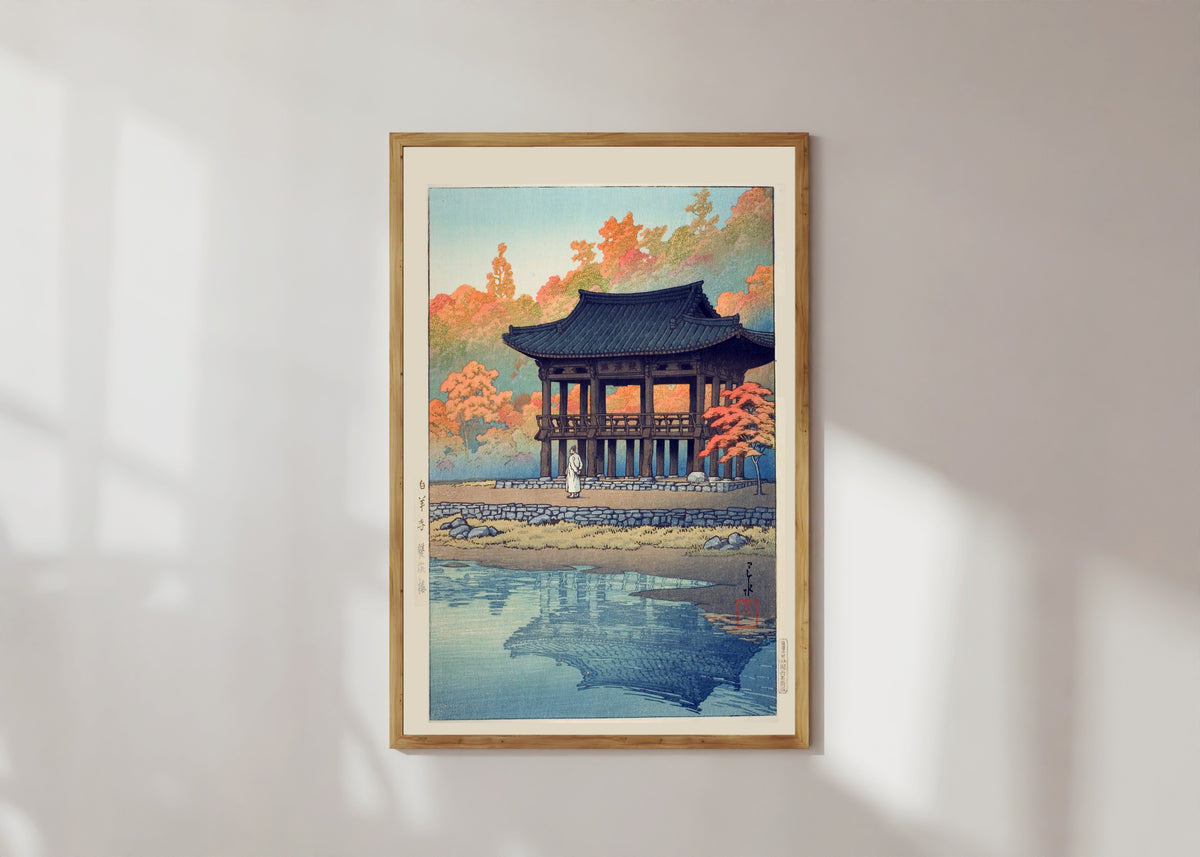Framed art print of Ssanggye Pavilion, Baegyangsa, Korea by Kawase Hasui, in a light wood frame on a sunlit white wall