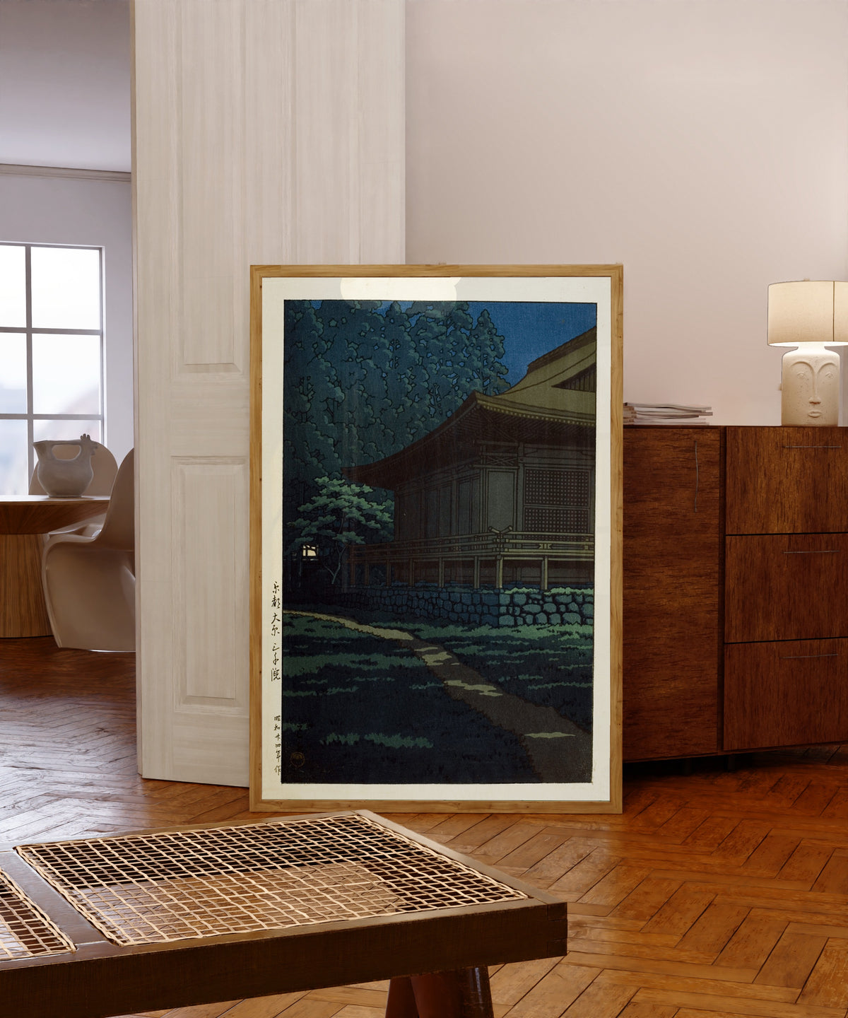 Framed art print of Sanzen-in Temple, Ohara, Kyoto by Kawase Hasui, in a light wood frame leaning in a warm room with a parquet floor