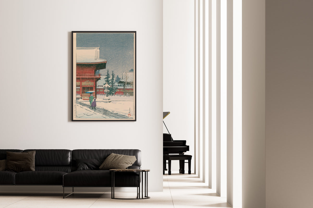 Framed art print of Snow at Nezu Gongen Shrine by Kawase Hasui, on the wall of a minimal living room