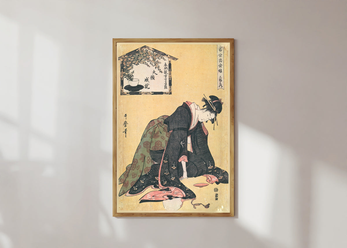 Framed art print of Naniwaya Okita, from Three Successful Girls of the Present Day (Kneeling) by Kitagawa Utamaro, in a light wood frame on a sunlit white wall